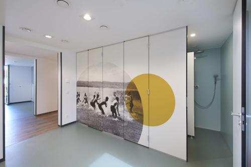 a wall mural in a hallway with a painting on it at Radhotel am Gleis in Radolfzell am Bodensee