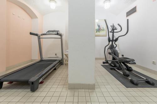 a gym with two tread machines in a room at Galerie Hotel Leipziger Hof in Leipzig