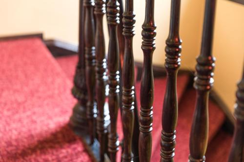 a row of wooden stairs with a red carpet at Galerie Hotel Leipziger Hof in Leipzig