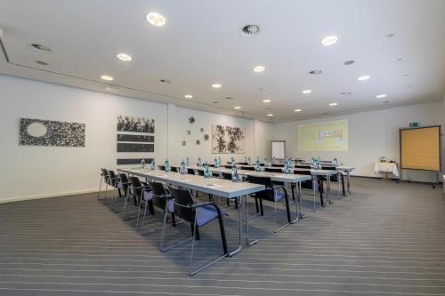 a large room with tables and chairs in it at Galerie Hotel Leipziger Hof in Leipzig