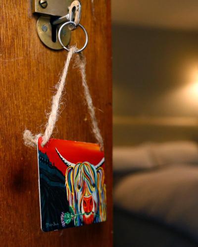 a key tag on a door with a cow on it at The Dunning Hotel in Perth