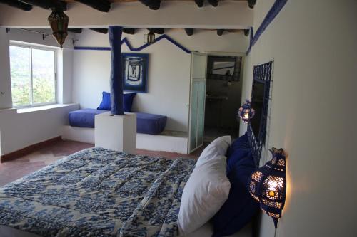a bedroom with a bed and a mirror in it at Kasbah de Ouirgane in Ouirgane
