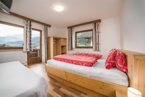 a bedroom with two beds and a window at Ferienhaus Oberanger in Kaltenbach