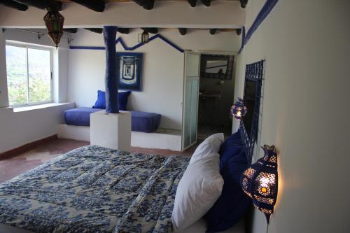 a bedroom with a bed and a mirror in it at Kasbah de Ouirgane in Ouirgane