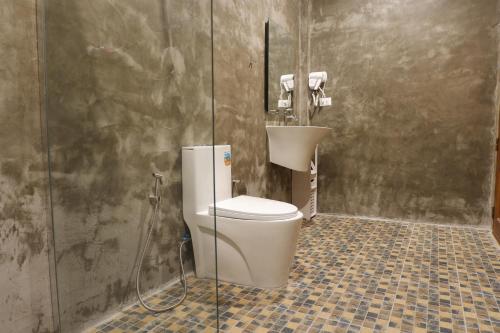 a bathroom with a toilet and a sink at The Bliss Khao Sok Boutique Lodge in Khao Sok