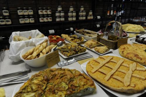 a table topped with lots of different types of food at Podere del Priorato in Albinia