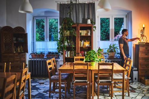 a man standing in a dining room with a table at Kraina Szeptów in Stronie Śląskie