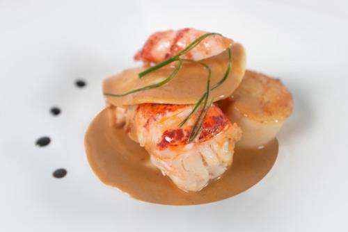 a piece of food on a plate with sauce at Hotel Hostellerie De La Gabelle in Saint-Florent-le-Vieil