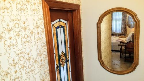 a mirror on a wall next to a door at Rezidence Zámeček - Boutique Hotel in Františkovy Lázně