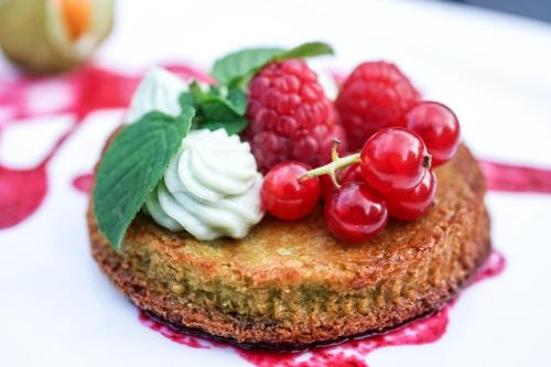 a dessert with berries and whipped cream and raspberries at GAME OF DOME in Chartrier-Ferrière