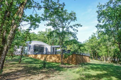 an exterior view of a dome tent in the woods at GAME OF DOME in Chartrier-Ferrière