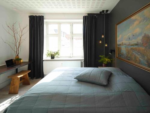 1 dormitorio con cama grande y ventana grande en Cozy Stay, en Aarhus