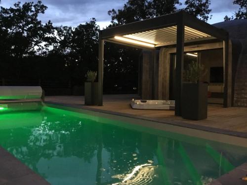 a swimming pool with a gazebo next to a swimming pool at GAME OF DOME in Chartrier-Ferrière