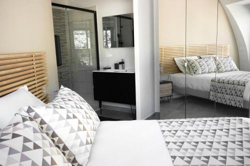 a bedroom with a bed and a bathroom with a sink at GAME OF DOME in Chartrier-Ferrière