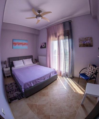 a bedroom with a bed and a ceiling fan at Luxury Villa Thea in Volos