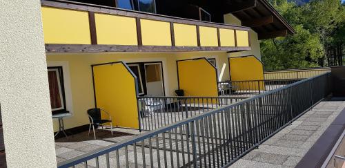 a building with yellow doors on the side of it at Hotel Forelle in Plansee