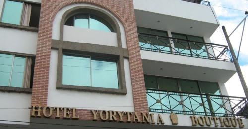 a building with a sign on the side of it at HOTEL YORYTANIA BOUTIQUE in Pitalito