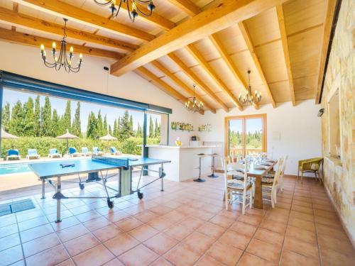 an open kitchen and dining room with ping pong tables at Villa Vertaient by Interhome in Alcudia