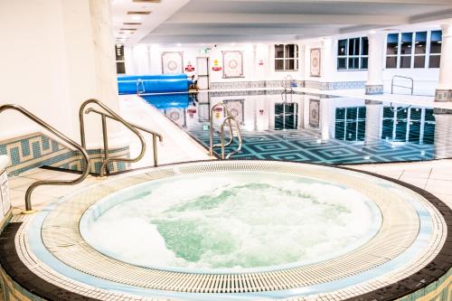 een jacuzzi in een gebouw met een zwembad bij Inishowen Gateway Hotel in Buncrana