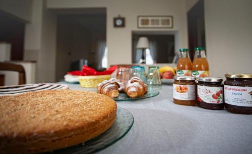 a table topped with a cake and jars of honey at I Quattro Grappoli in Neive