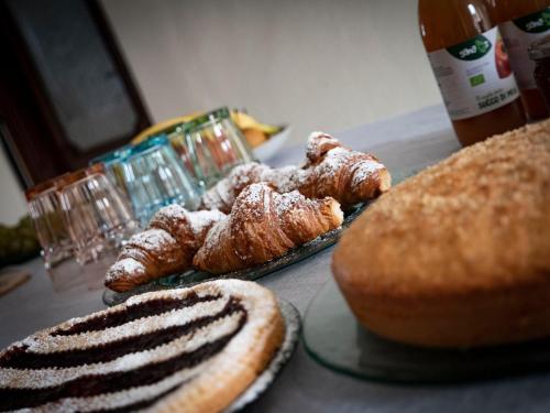 a table with various pastries and breads on it at I Quattro Grappoli in Neive
