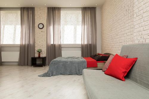 a living room with a bed and a brick wall at Apartments on Krasnozvezdnaya st.31 in Nizhny Novgorod
