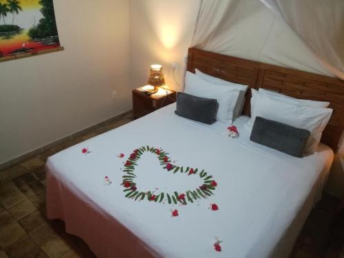 a bed with a christmas decoration on it at Pousada Berro do Jeguy in Pipa