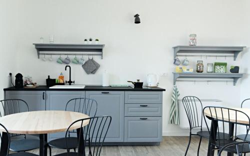 a kitchen with blue cabinets and a table and chairs at La Selce Farmhouse in Bagnaria Arsa