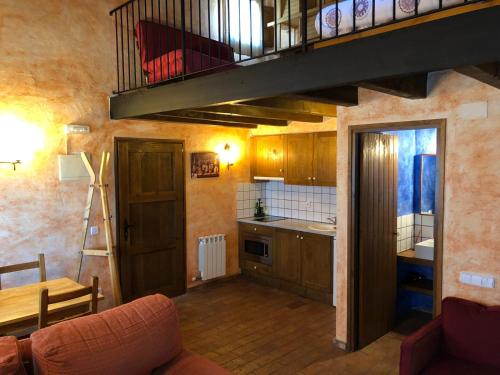 a kitchen with a staircase and a living room at Apartaments Alzina in Tavertet