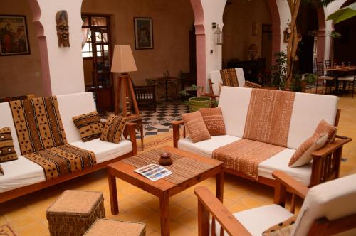 a living room with couches and a coffee table at Dar Essaada in Essaouira