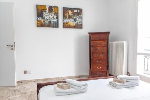 a bedroom with a bed and a wooden dresser at gatis house in Naxos Chora