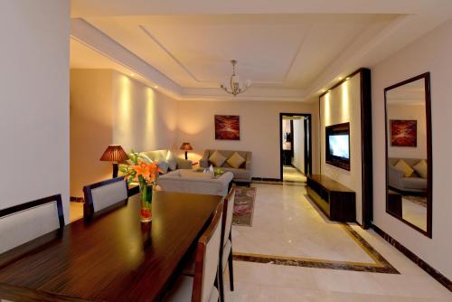 a living room with a table and a couch at Boudl Al Woroud بودل الورود in Riyadh