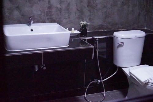 a bathroom with a sink and a toilet at S.S.Hotel Nangrong in Nang Rong