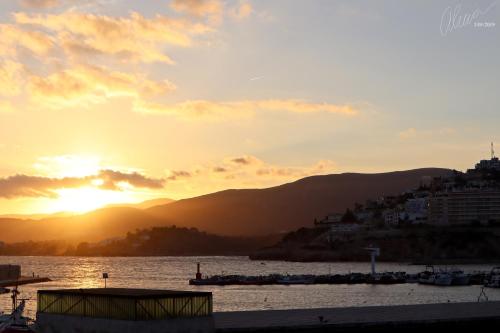 a sunset over a body of water with a city at Hostal Boutique Olvido 22 Adults Only in Peñíscola