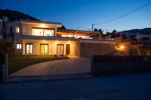 a large house at night with the lights on at Luxury Villa Panorama in vlicha