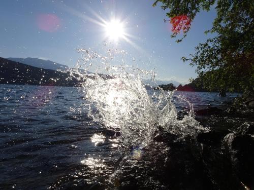 a splash of water in front of a body of water at Apartments Krista in Seeboden