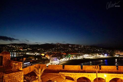 a view of a city at night with a body of water at Hostal Boutique Olvido 22 Adults Only in Peñíscola