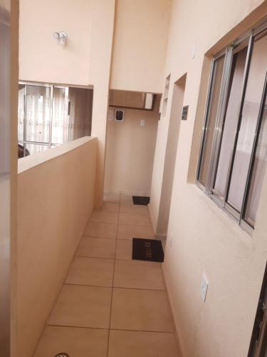 a hallway in an office building with a hallway at Pousada Castro in Aparecida