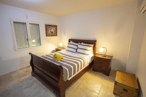 a bedroom with a bed with a yellow stuffed animal on it at Aqua Breeze Apartment in Kralendijk