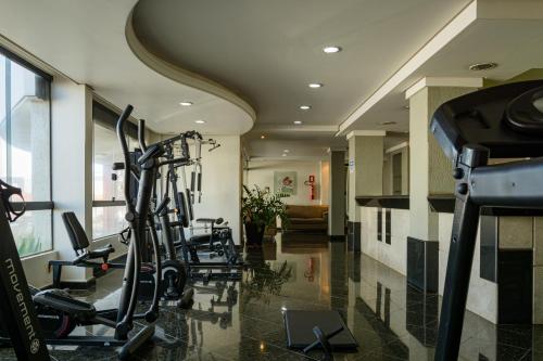 a gym with cardio equipment in a hotel room at Lindóya Hotel in Catalão