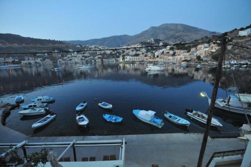 a group of boats are docked in a harbor at Odyssia in Symi