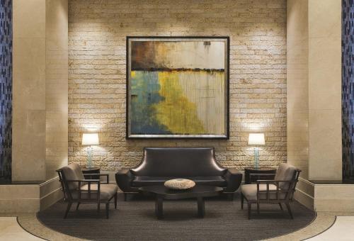 a lobby with a couch and chairs and a painting at The Signature at MGM Grand - All Suites in Las Vegas