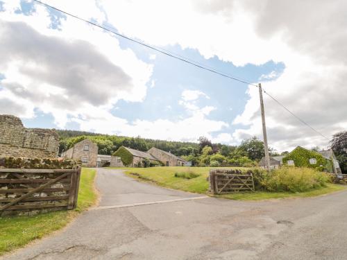 an empty road with a wooden fence and houses at The Steadings in Morpeth