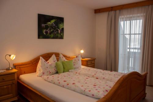 a bedroom with a bed and a window at Zauscherhof in Wildermieming