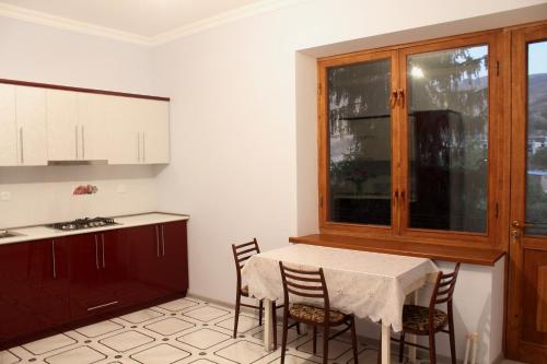 a kitchen with a table and chairs and a window at Anna Home B&B in Areni