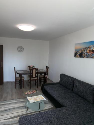 a living room with a couch and a table at Apartament TT10 Botanicka in Trnava