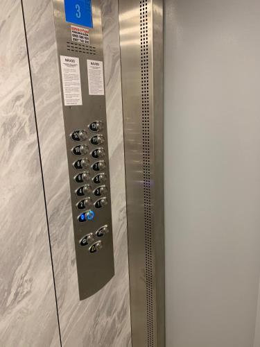 a elevator door with a bunch of wine bottles at Apartament TT10 Botanicka in Trnava