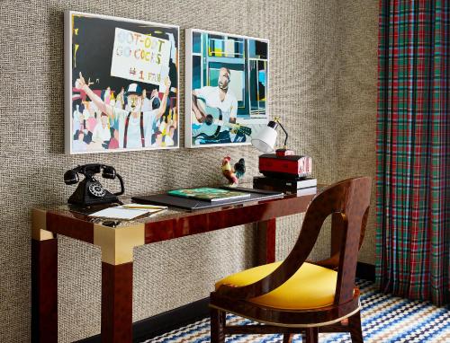 a desk with a chair and a lamp on it at Graduate by Hilton Columbia SC in Columbia