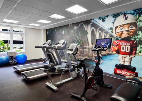 a gym with a mural of a football player on the wall at Graduate Columbia, SC in Columbia