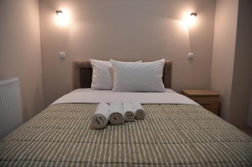 a bed with two towels on top of it at Olimp in Kraljevo